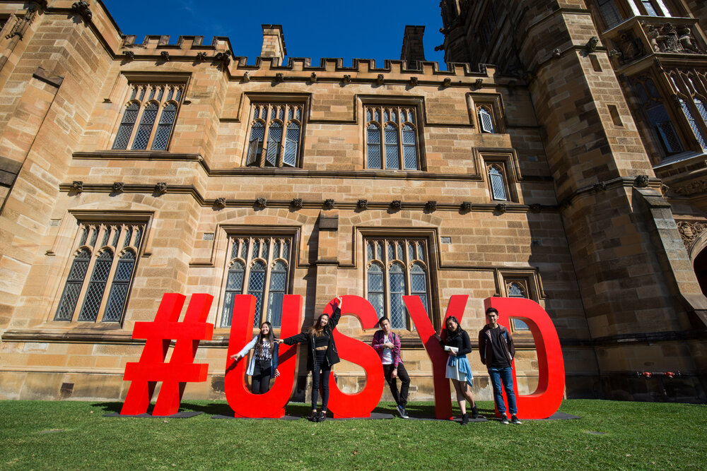 Students with Open Day USYD Sign at Quadrangle
