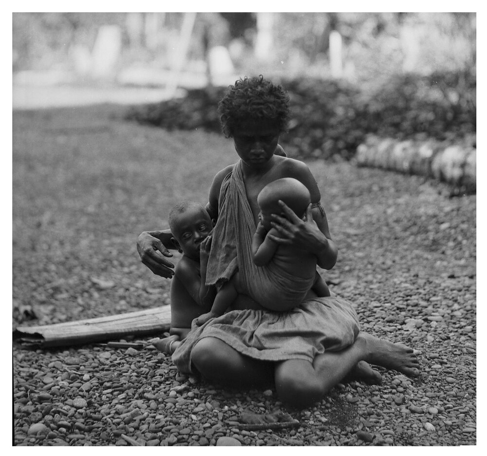 Woman Suckling Two of Her Children at Once