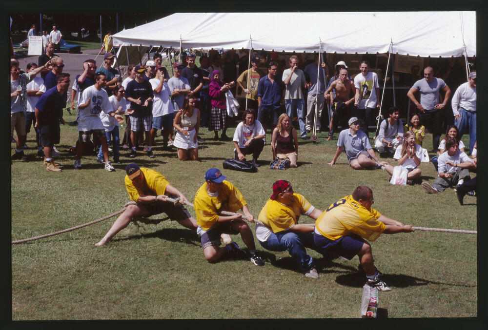 Students in Tug of War on Front Lawn During Orientation