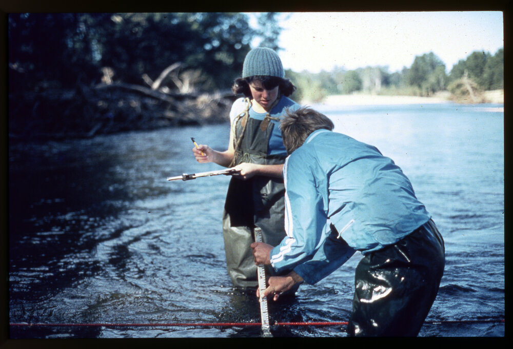 Two Science Students Taking Measurements in River