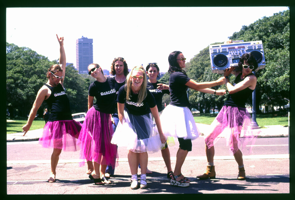 Dance Soc Member in Tutu's Posing on Front Lawn