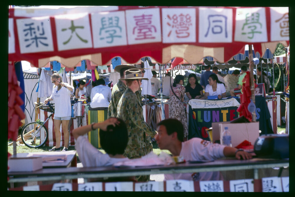 Stalls at Orientation/O-Week with a Student in Army Reserve Uniform Walking Through