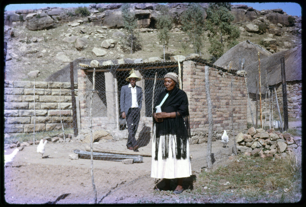 Man and Woman Outside Chicken Coop