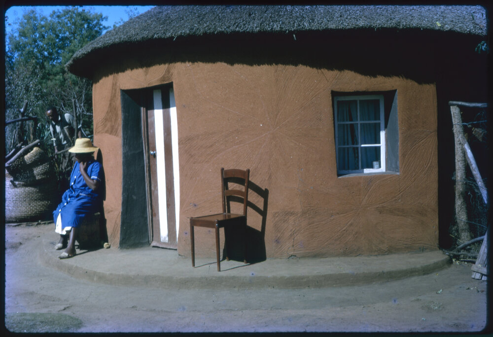 Woman Sitting Outside Building