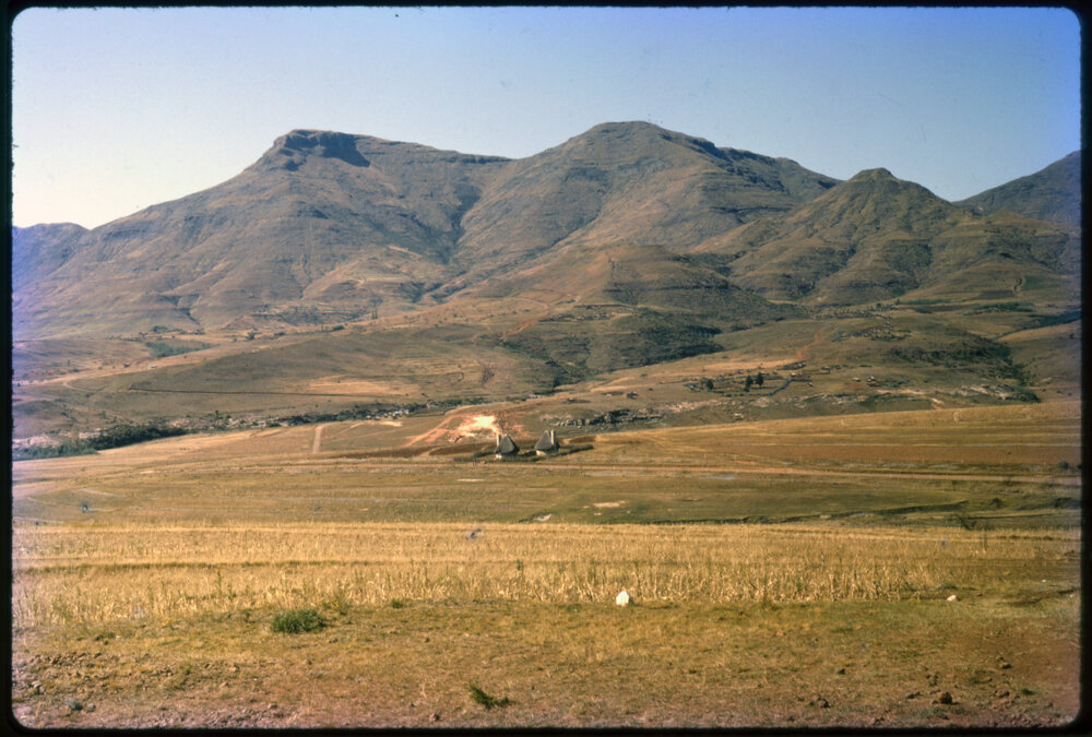 View Over Land with Buildings and Mountains