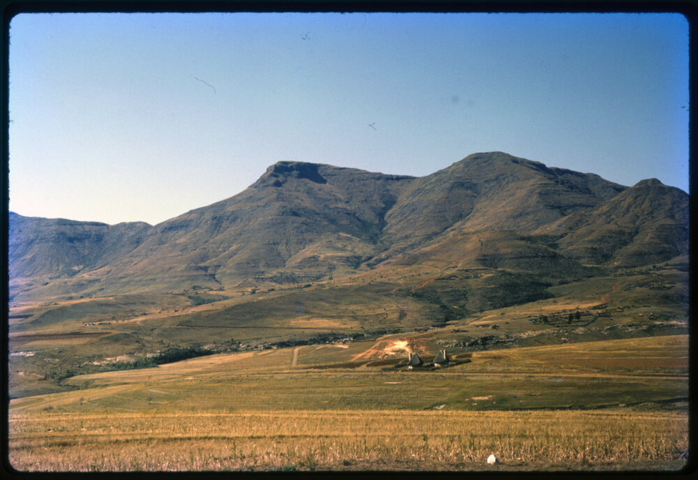View Over Land with Buildings and Mountains