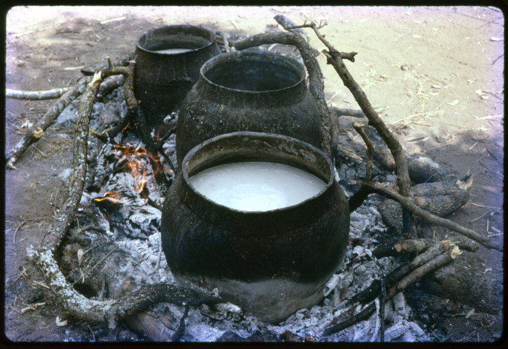 Pots of Food Cooking Over Fire