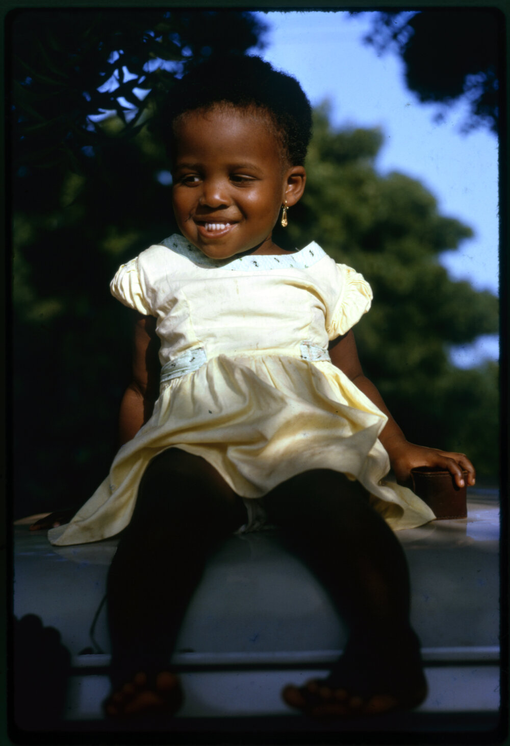 Girl Sitting on Car Roof
