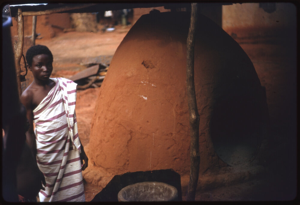 Person Next to Clay Oven
