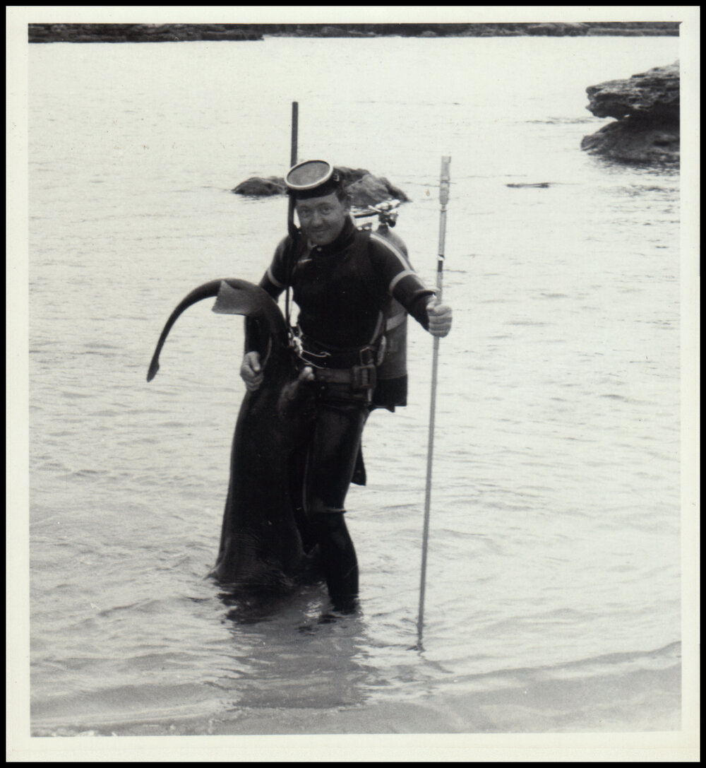 John Thompson Holding a Speared Fish