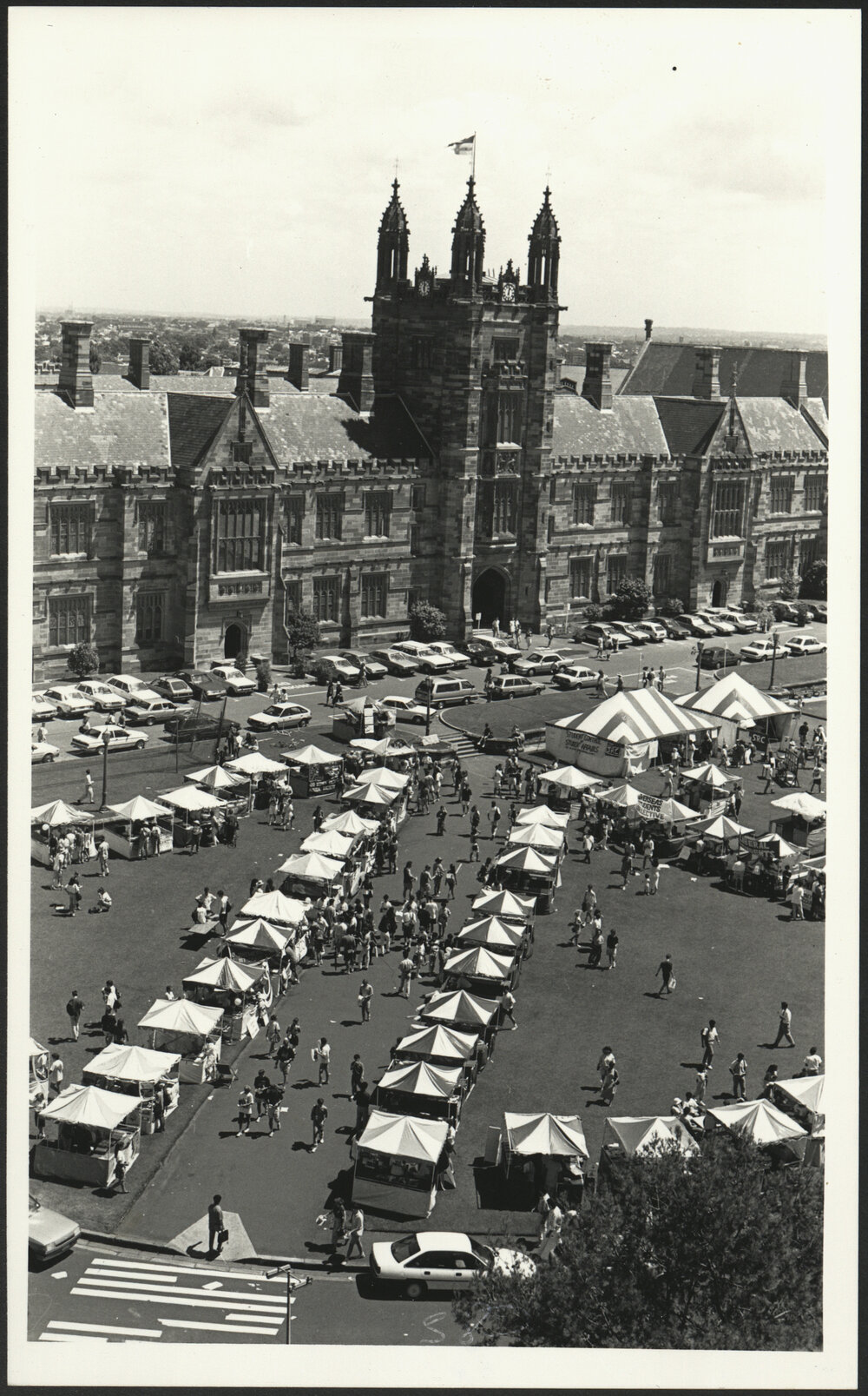 Stalls on Welcome Day with Cars Parked in Front of Main Building as Seen from Above Library Building