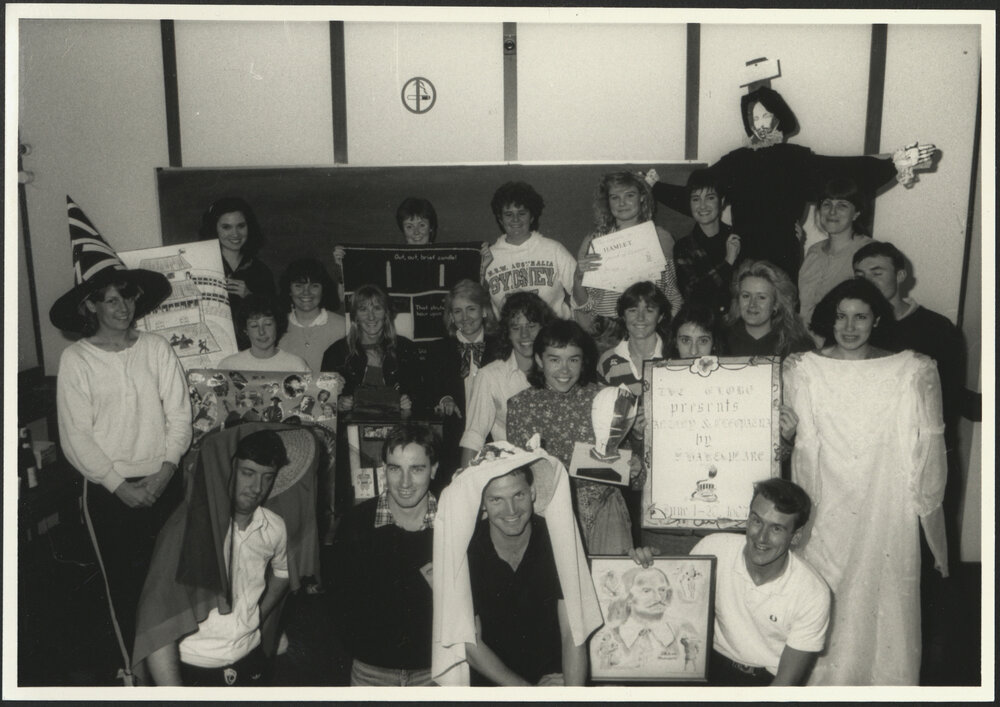 Group Photo of Students from the Teaching Shakespeare Unit Displaying Posters and Costume Items