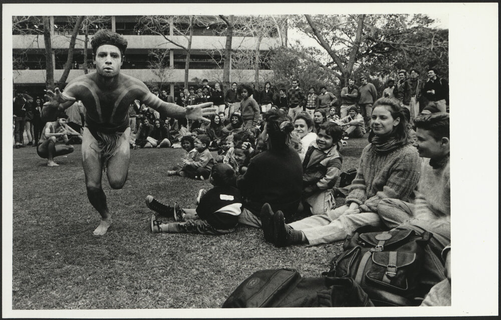 Aboriginal Dancer in Front of a Watching Crowd with Didgeridoo Player at the Back