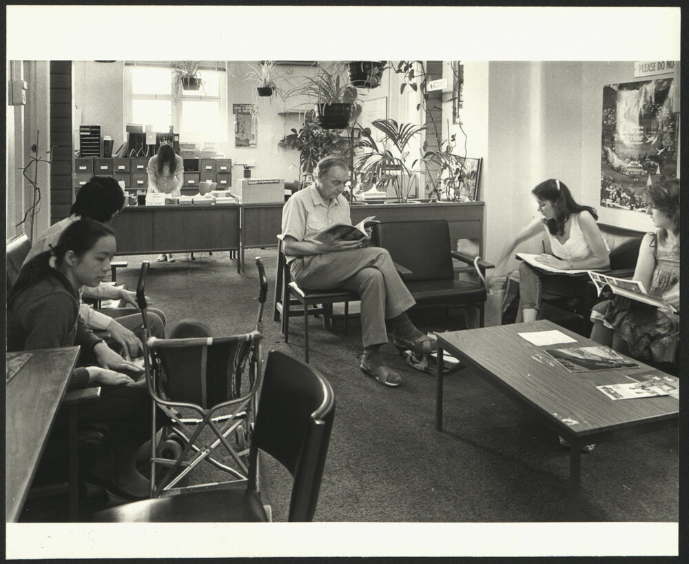 Students and Staff Sitting in the University Health Service Waiting Room with Reception Desk in Background