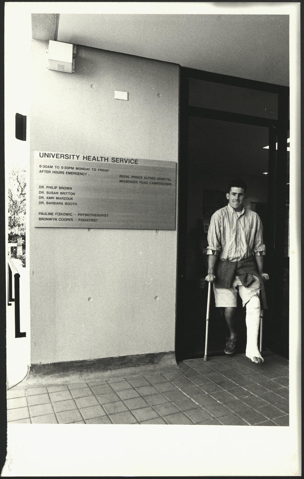 A Patient on Crutches with His Left Leg in Plaster Is Exiting the University Health Service