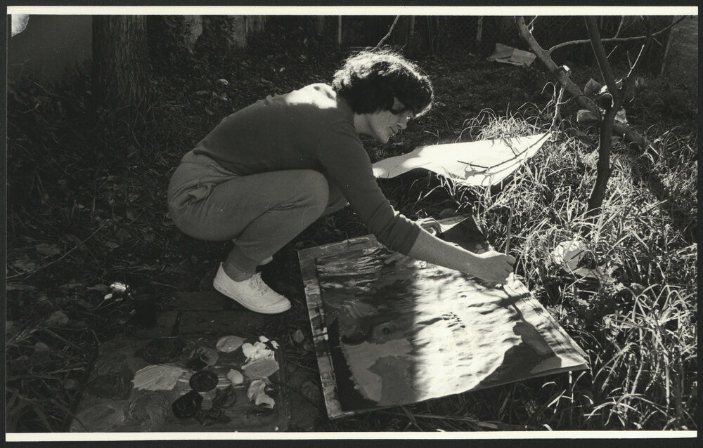 A Student Painting a Picture or Poster in the Outdoors at an Art Workshop