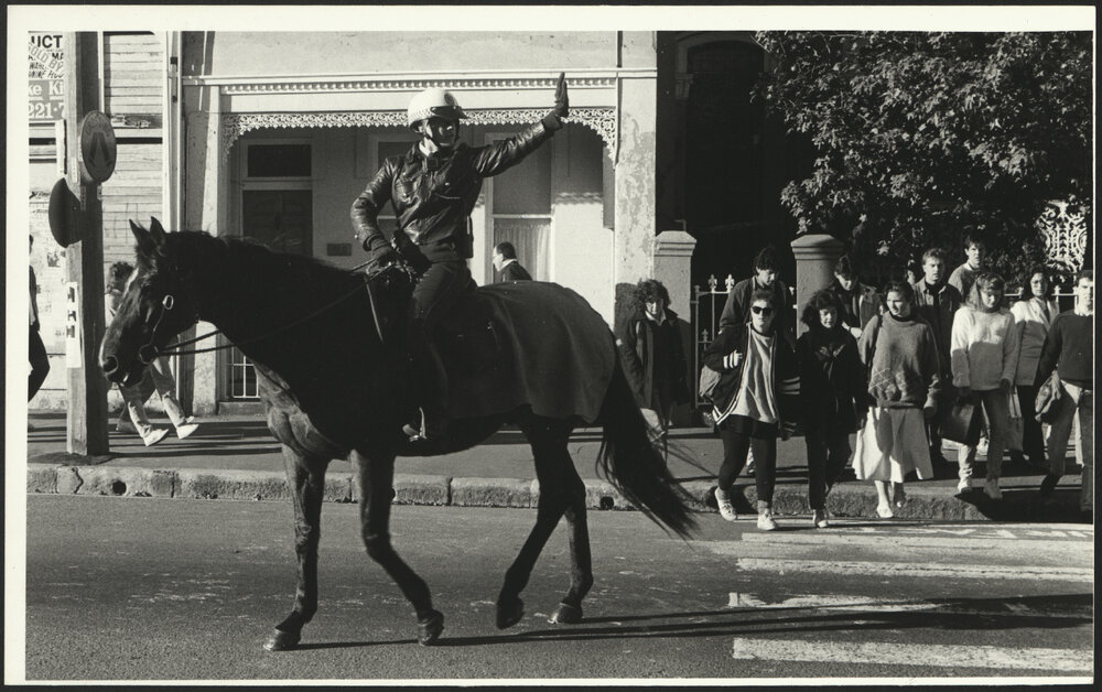 Student Foot Traffic to the University with Traffic Regulated by Police on Horseback