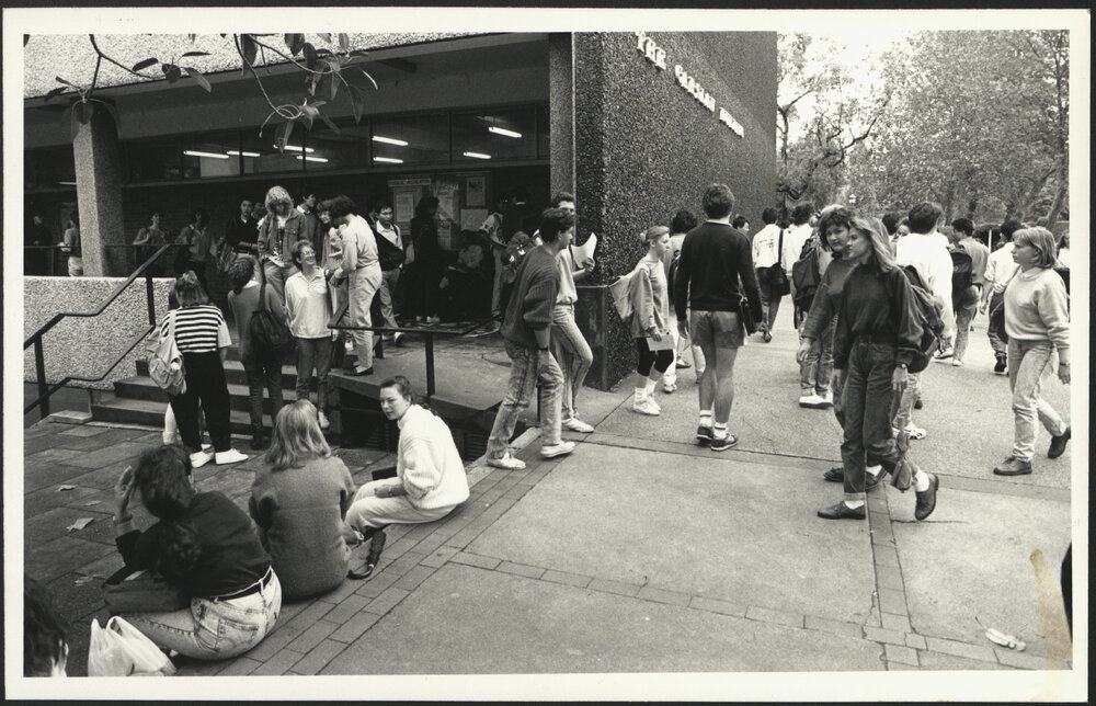 Students Standing and Walking Near the Entrance to the Carslaw Building