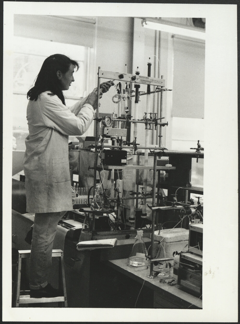 Agriculture Student Setting Up an Experiment on Scientific Apparatus
