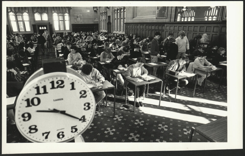 Students in Examination in MacLaurin Hall with Large Centre Clock Showing Time at Bottom Left-Hand Side