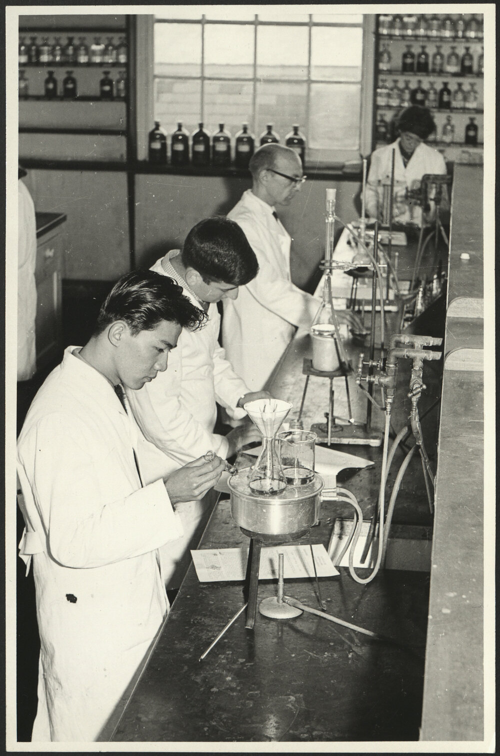 Pharmaceutical Chemistry Laboratory Students Preparing Medicines at a Lab Bench