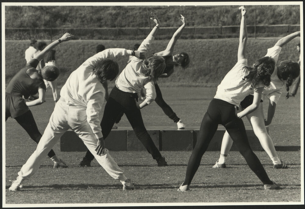 Sport and Recreation - A Group of Women Undertaking Stretching Exercises on the Oval