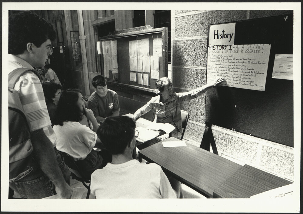 Enrolment Time - Directional Signage in the Cloisters and Lecturer Providing Information on History