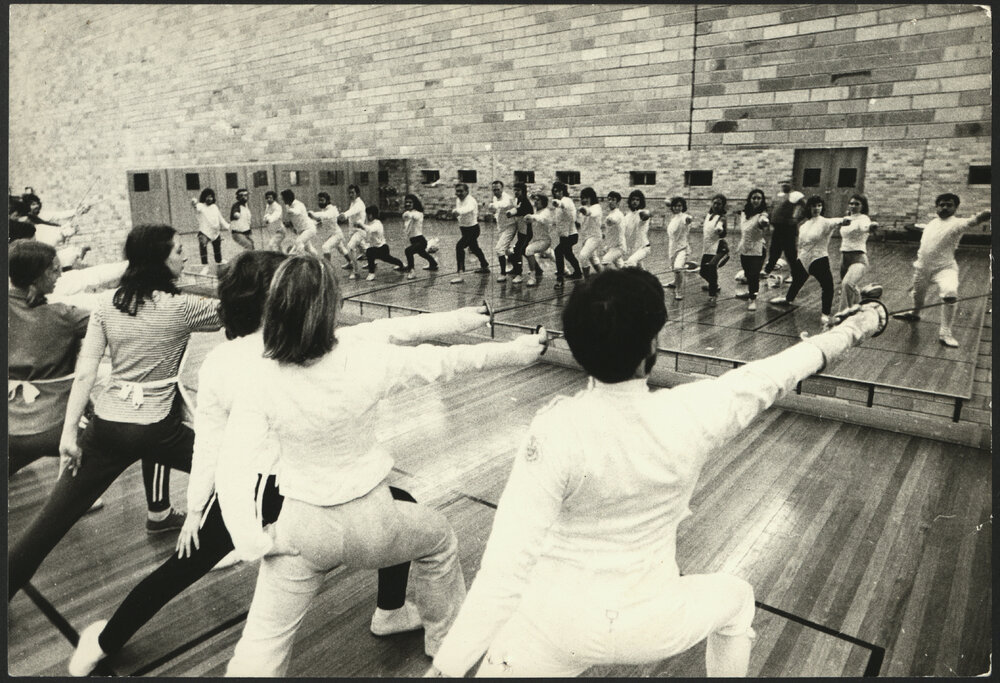 Sport and Recreation - Students Practicing Fencing in Front of a Mirror
