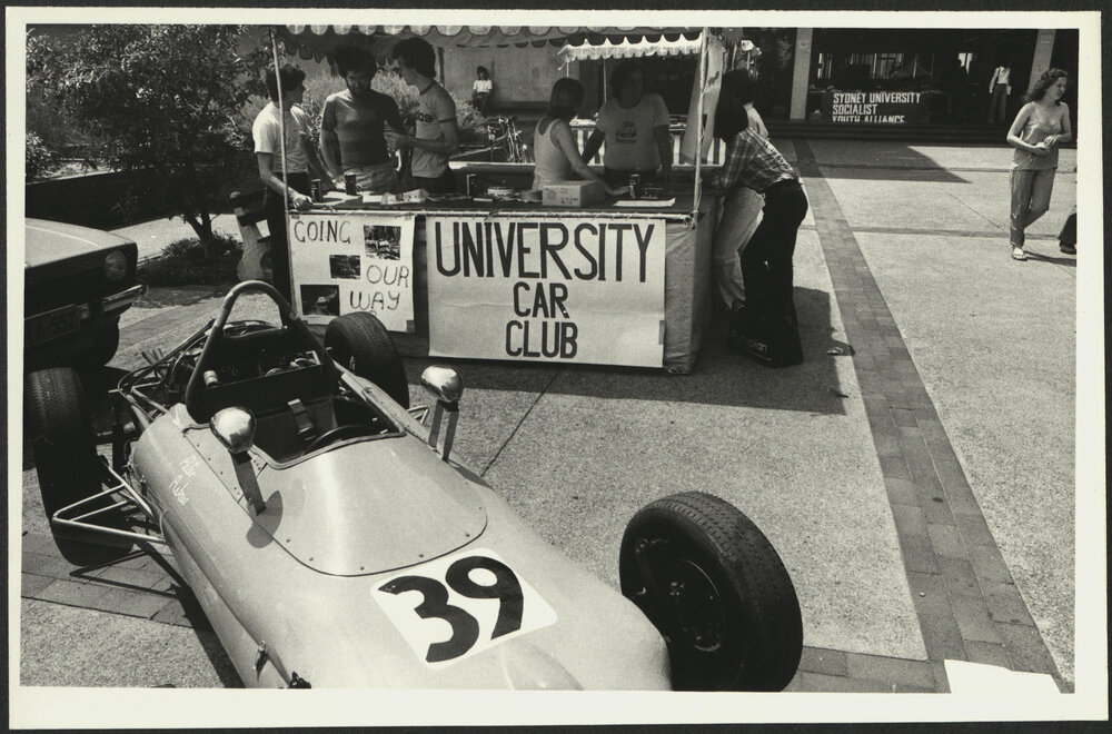 University Car Club Stand at O Week with a Race Car on Display