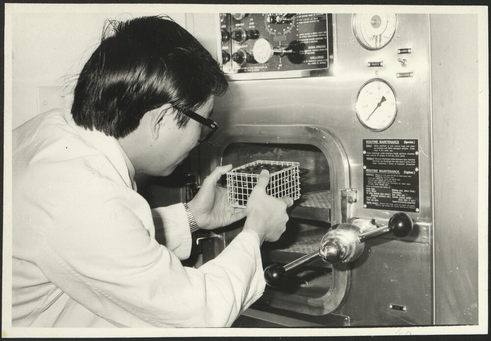 Pharmaceutical Chemistry Laboratory a Student Placing a Wire Basket with Medicine (?) into an Autoclave