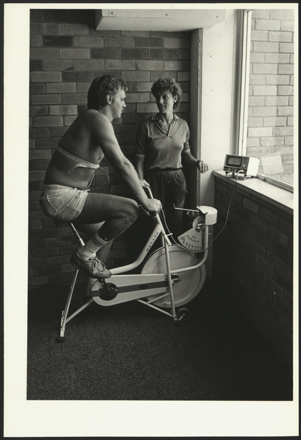 Sport - Health Monitoring Student on an Exercise Bike Being Monitored