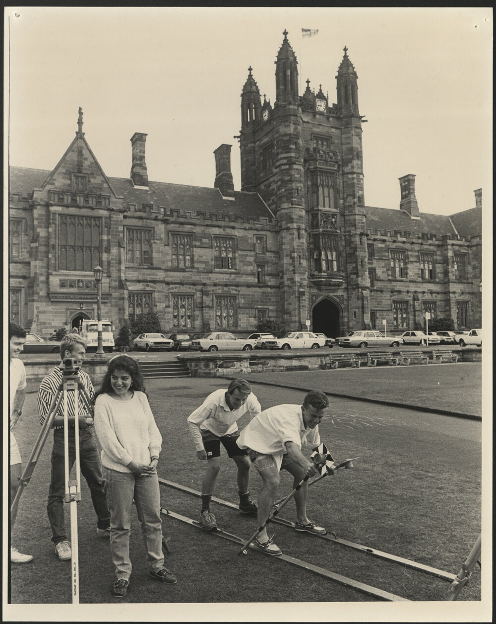 Surveying Students on Front Lawn with Two Students Pretending to Ski Using Their Measurements