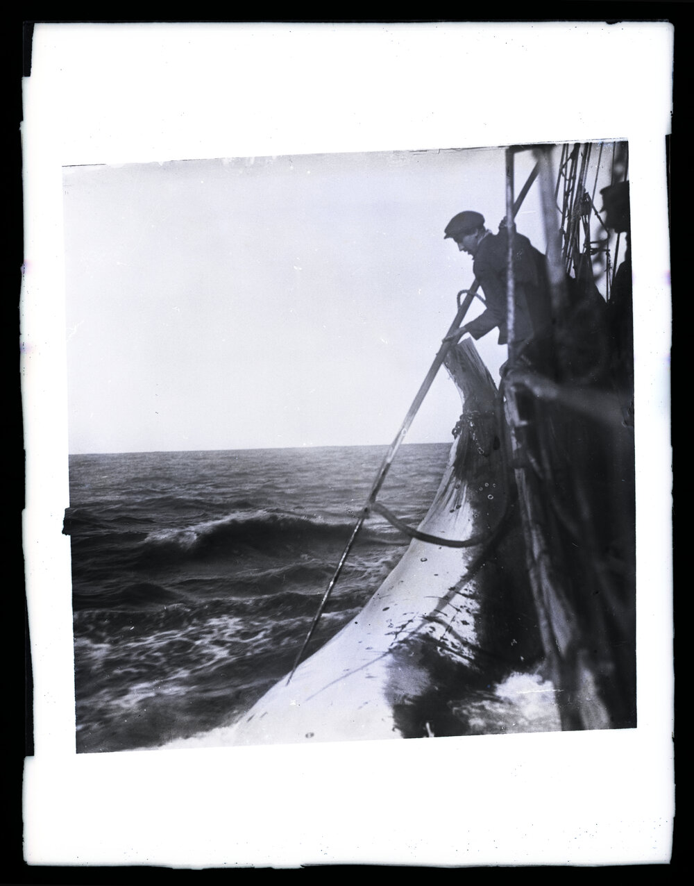 Man Leaning over Ship