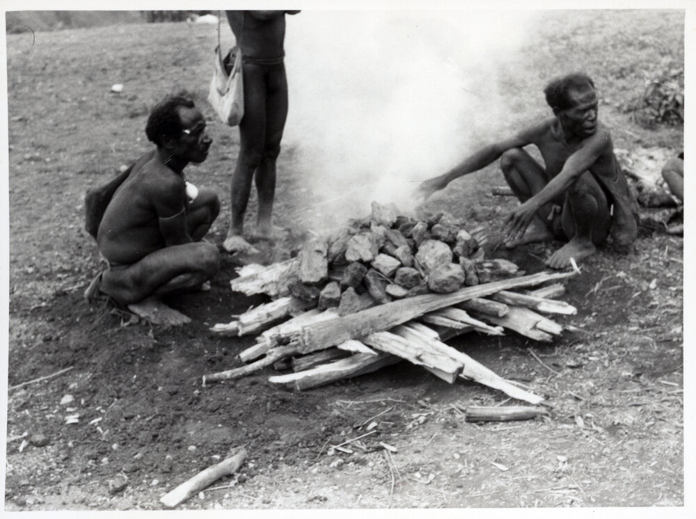 Men Sitting Around a Fire