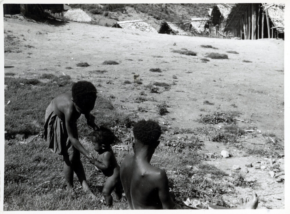 Adult and Two Children Standing Near Hamlet