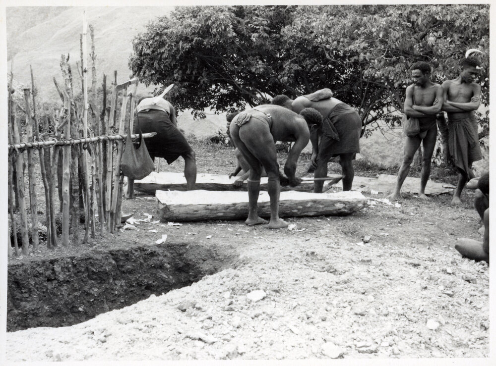 Men Preparing a Log Coffin