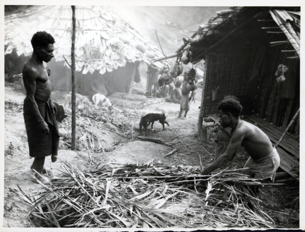 Men Preparing Sticks and Leaves
