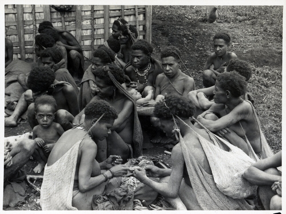 Group Sitting, Some with Net Bags