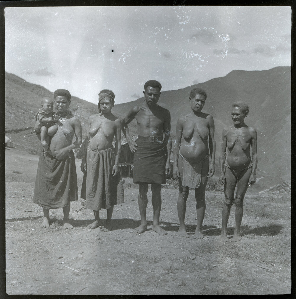 One Man and Four Women, With One Carrying a Baby