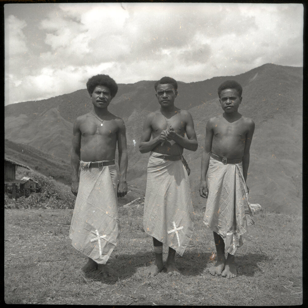 Three Men With Crosses Sewn on Clothing