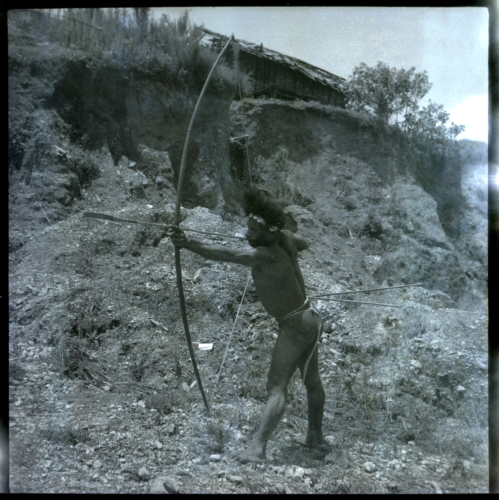 Man Posing with Bow