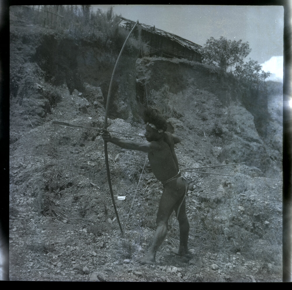 Man Posing with Bow
