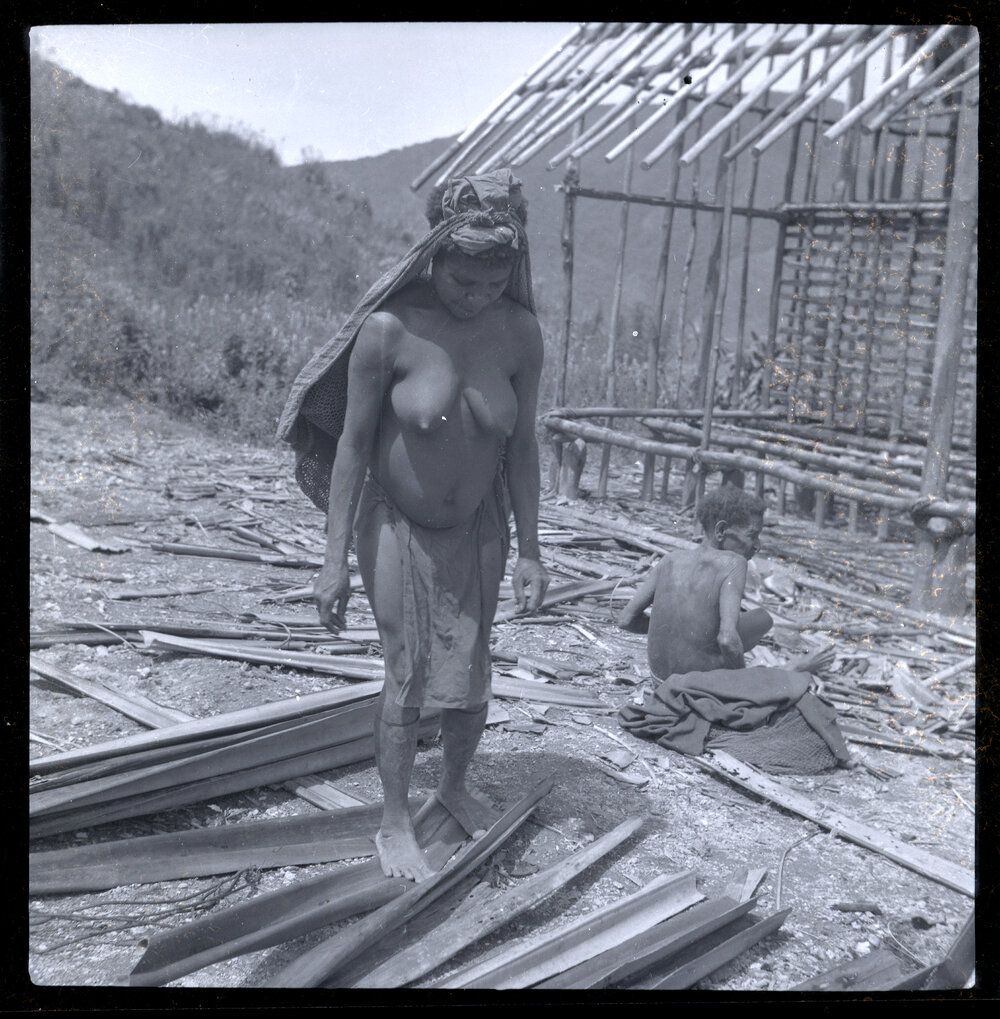 Woman Standing in Front of Partially-Constructed Building
