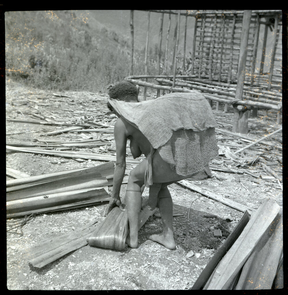 Woman Standing in Front of Partially-Constructed Building