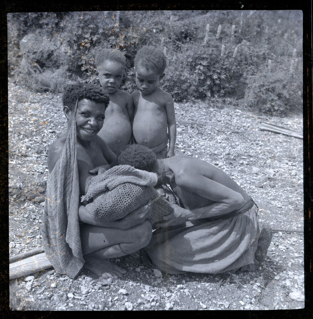Mother Showing Baby to Women and Children