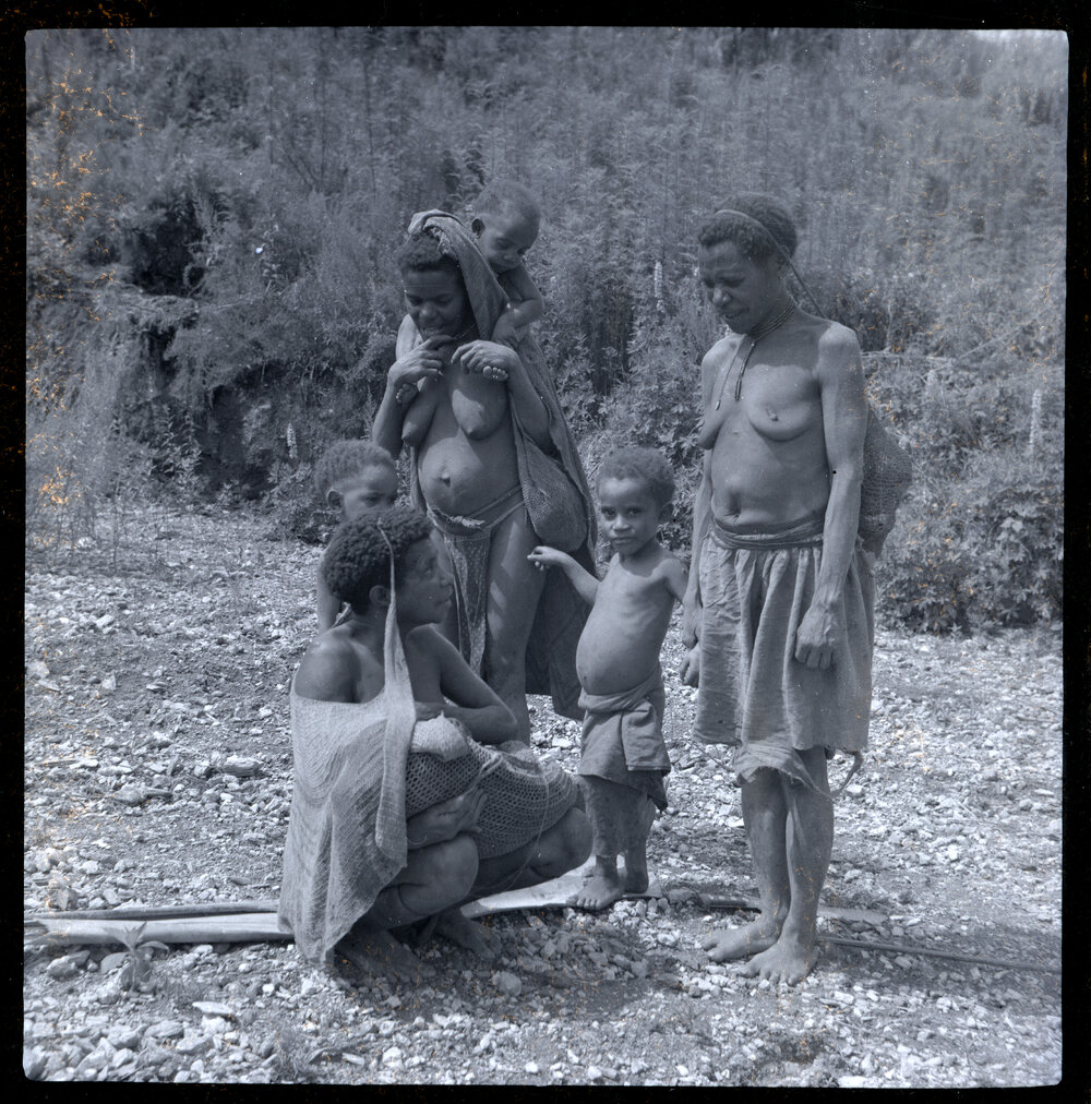 Mother Showing Baby to Women and Children