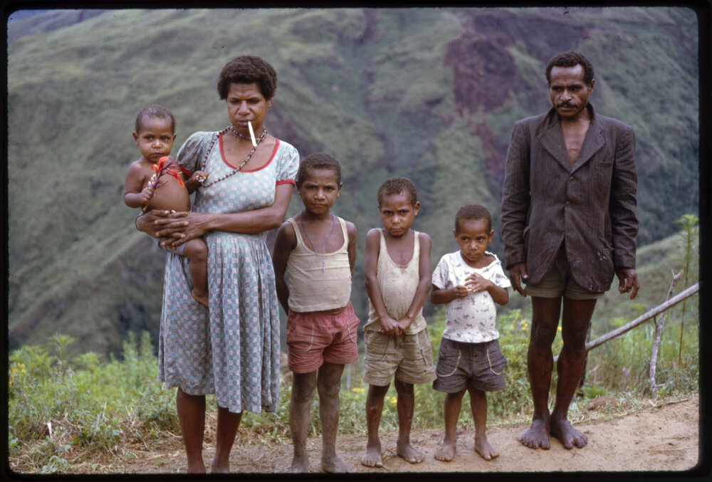 Man, Women and Four Children Standing on Mountainside