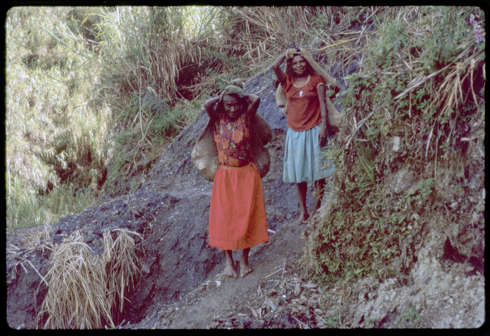 Women with Net Bags on Mountain Path