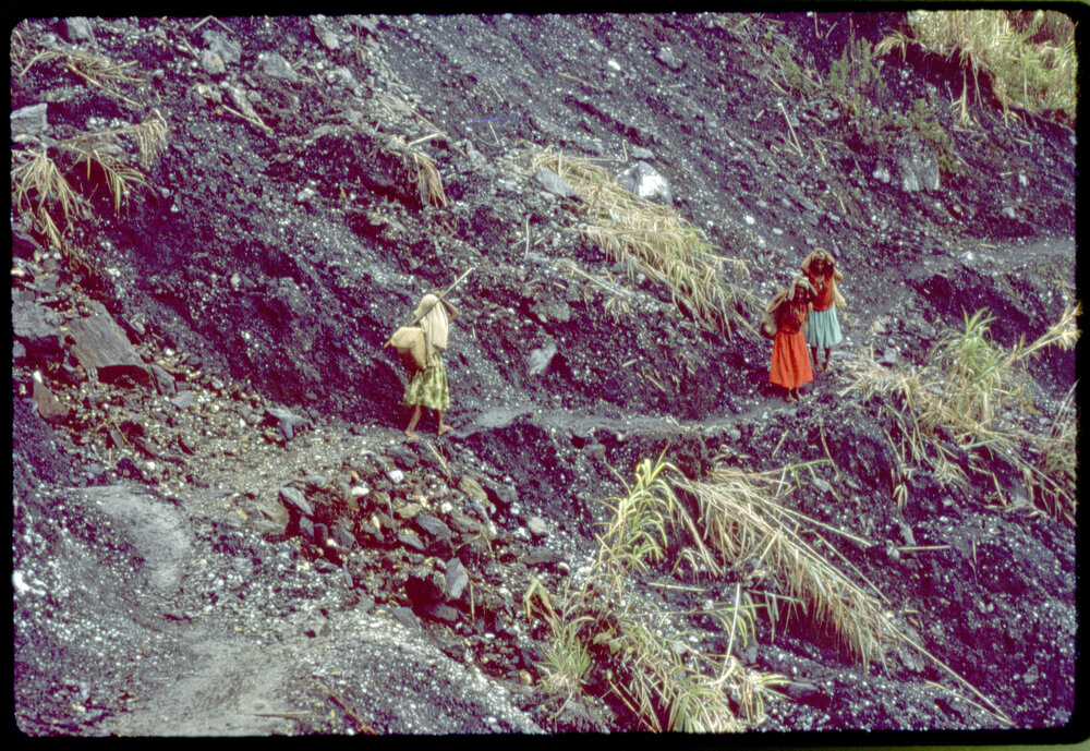 Three Women with Net Bags on Mountain Path