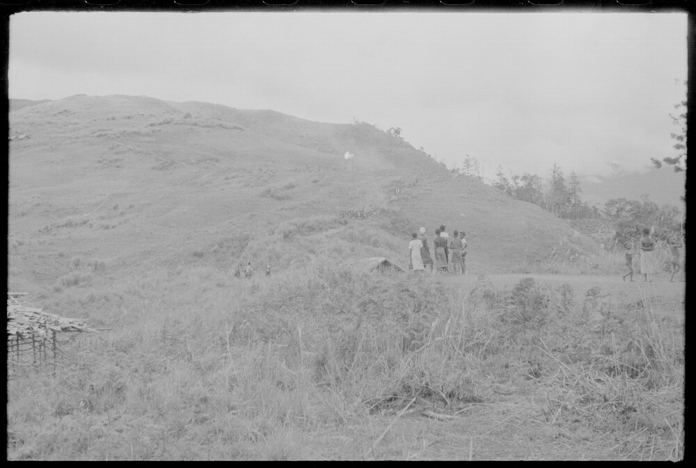 Groups of People Gathered Across Mountain